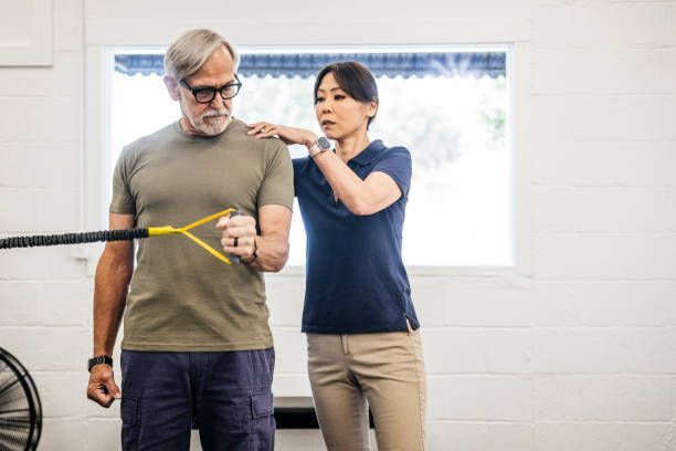 Man doing physical therapy exercises using a stretch band