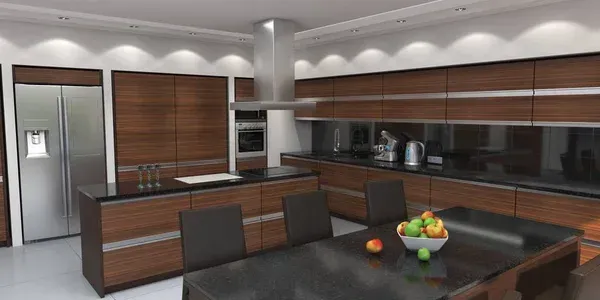 Modern kitchen with stainless steel appliances, dark wood cabinets, dining table, and fruit bowl