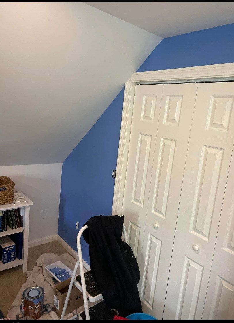 A room with blue walls and white doors