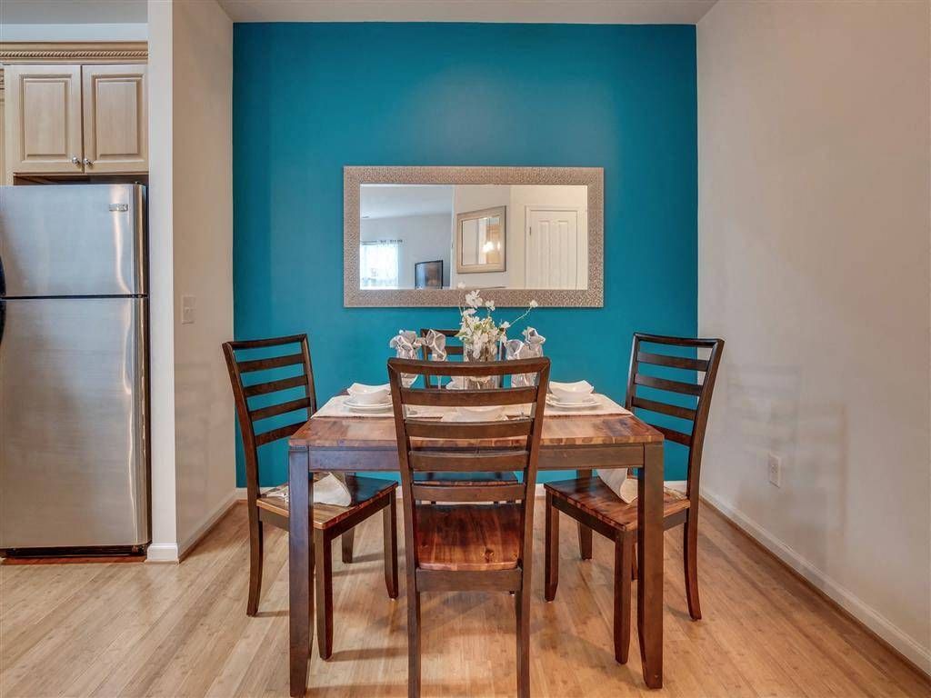 Dining table with blue accent wall.