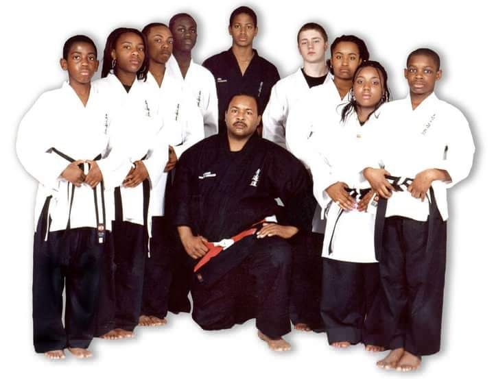 a group of martial arts students pose for a photo