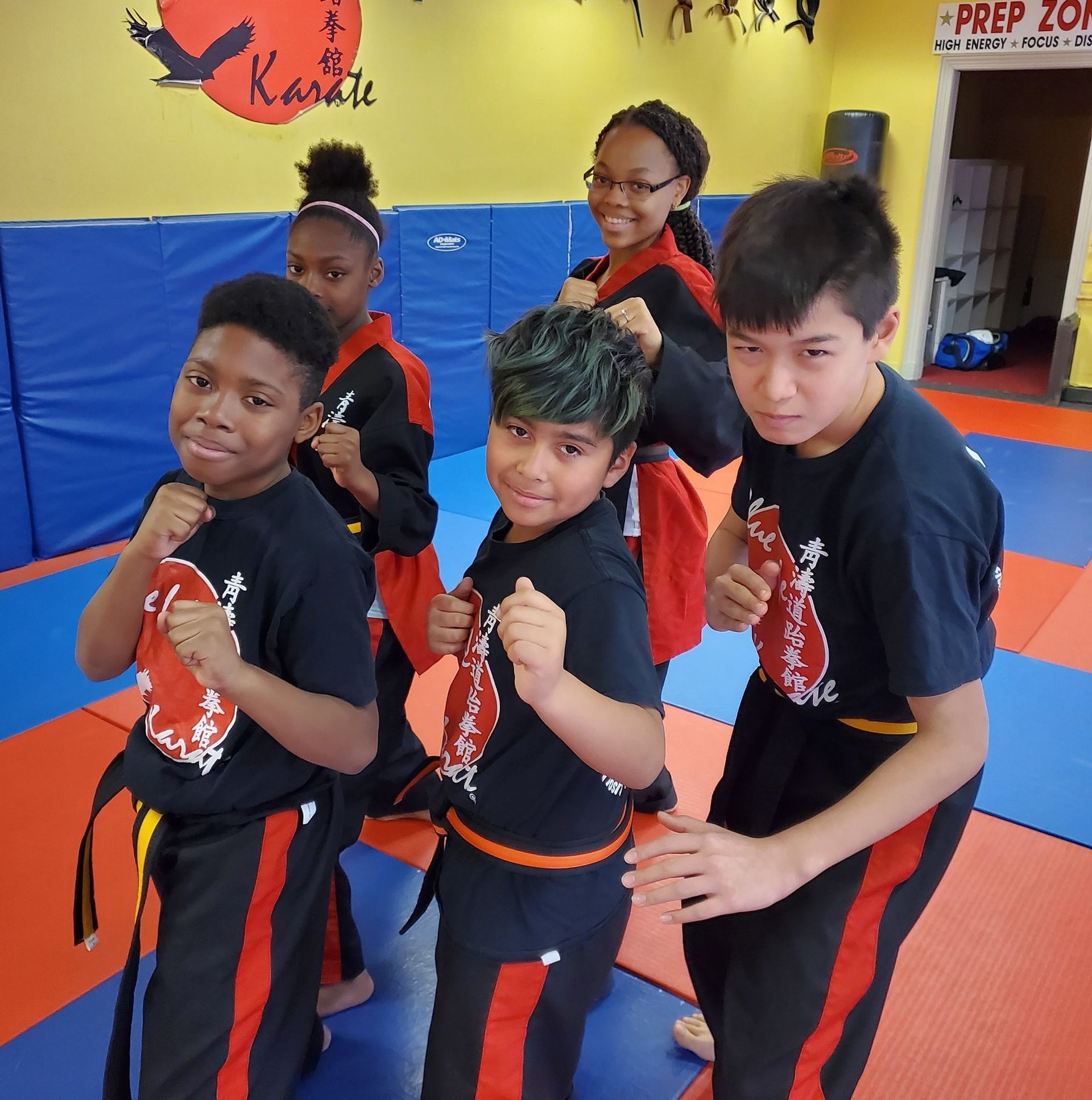 a group of kids are posing for a picture in front of a sign that says prep zone