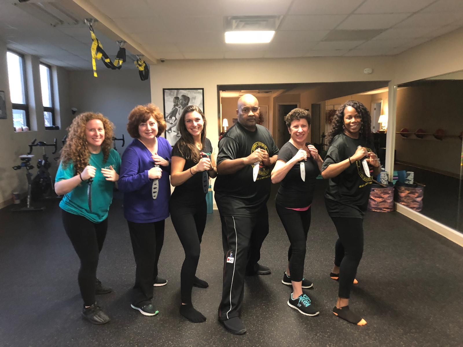 a group of people are posing for a picture in a gym .