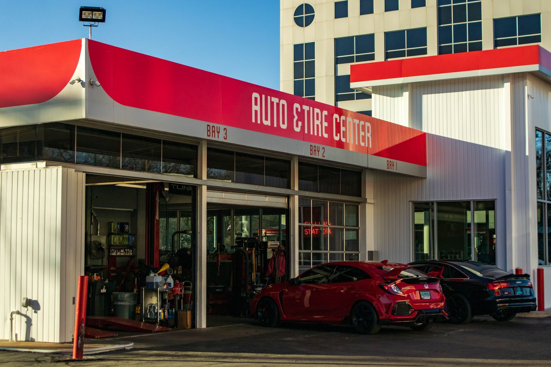 two cars parked out front, one red and one black | Reeder's Auto & Tire Blog