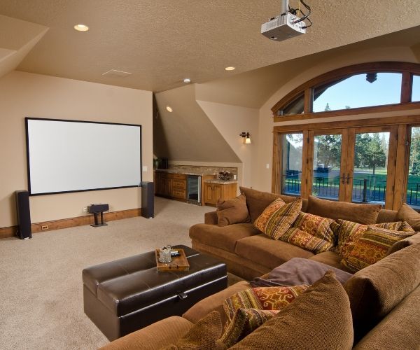 A living room with a projector screen and a couch