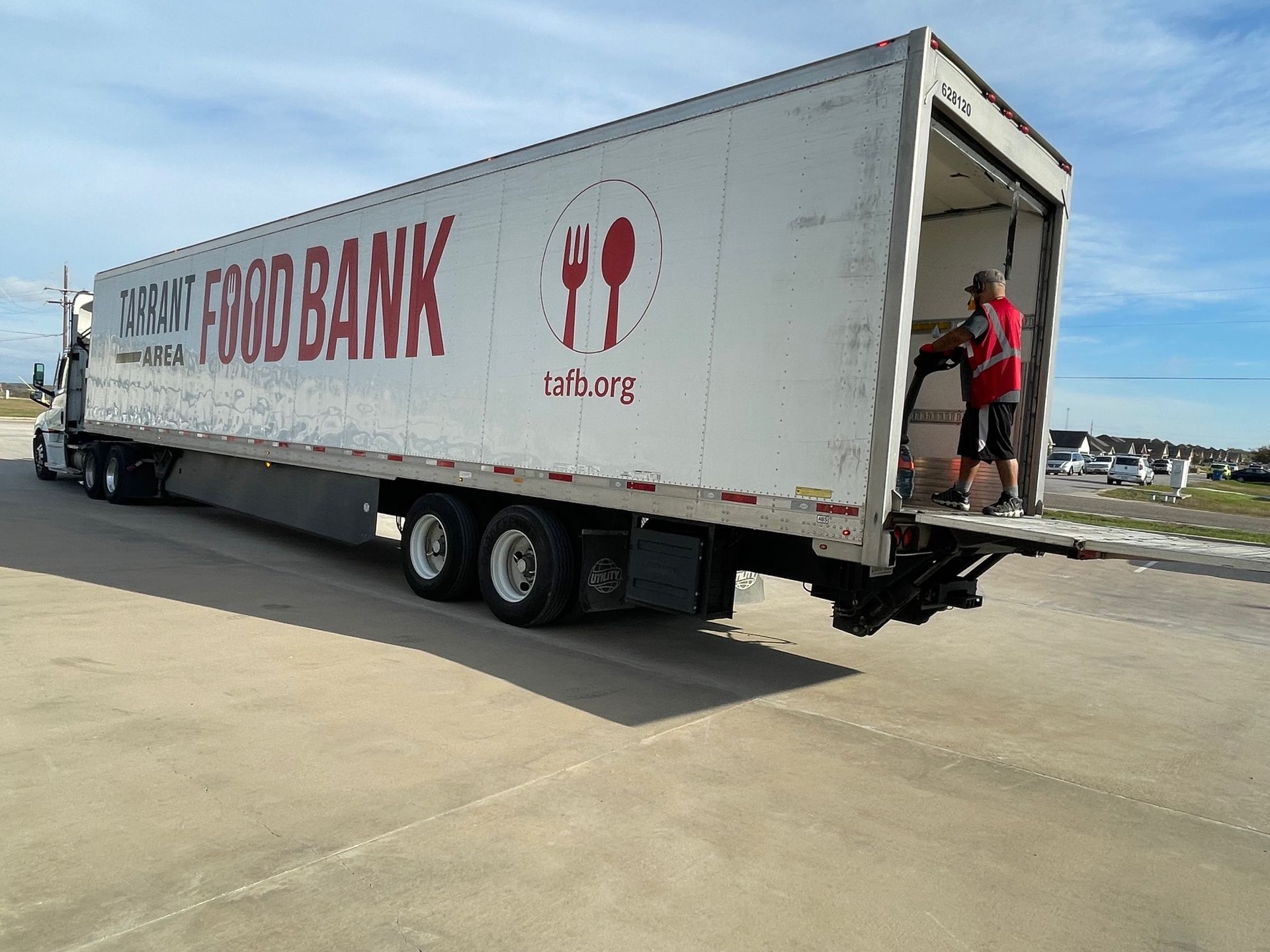 A truck is parked in front of a building that says our daily bread food bank.