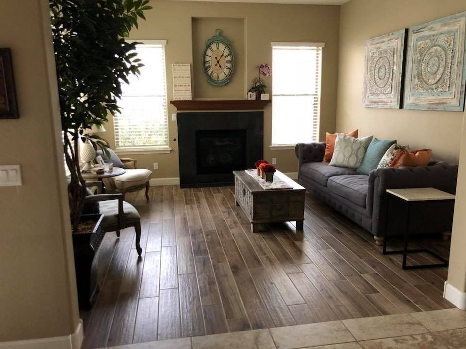 A living room with a fireplace and a clock on the wall