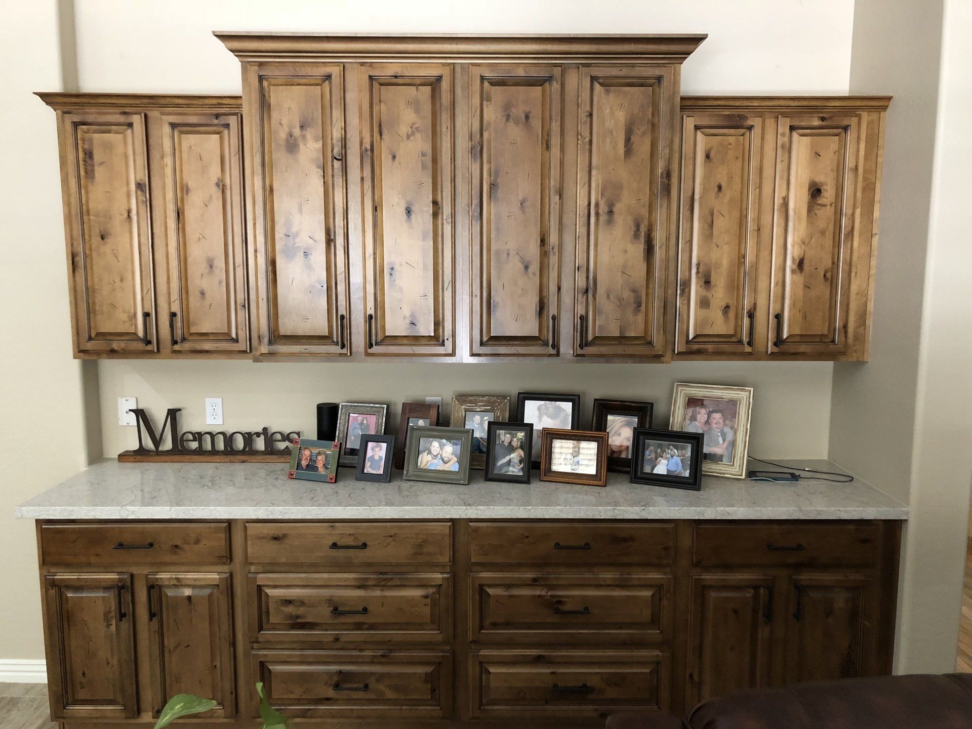 A kitchen with wooden cabinets and drawers and a sign that says minnie.