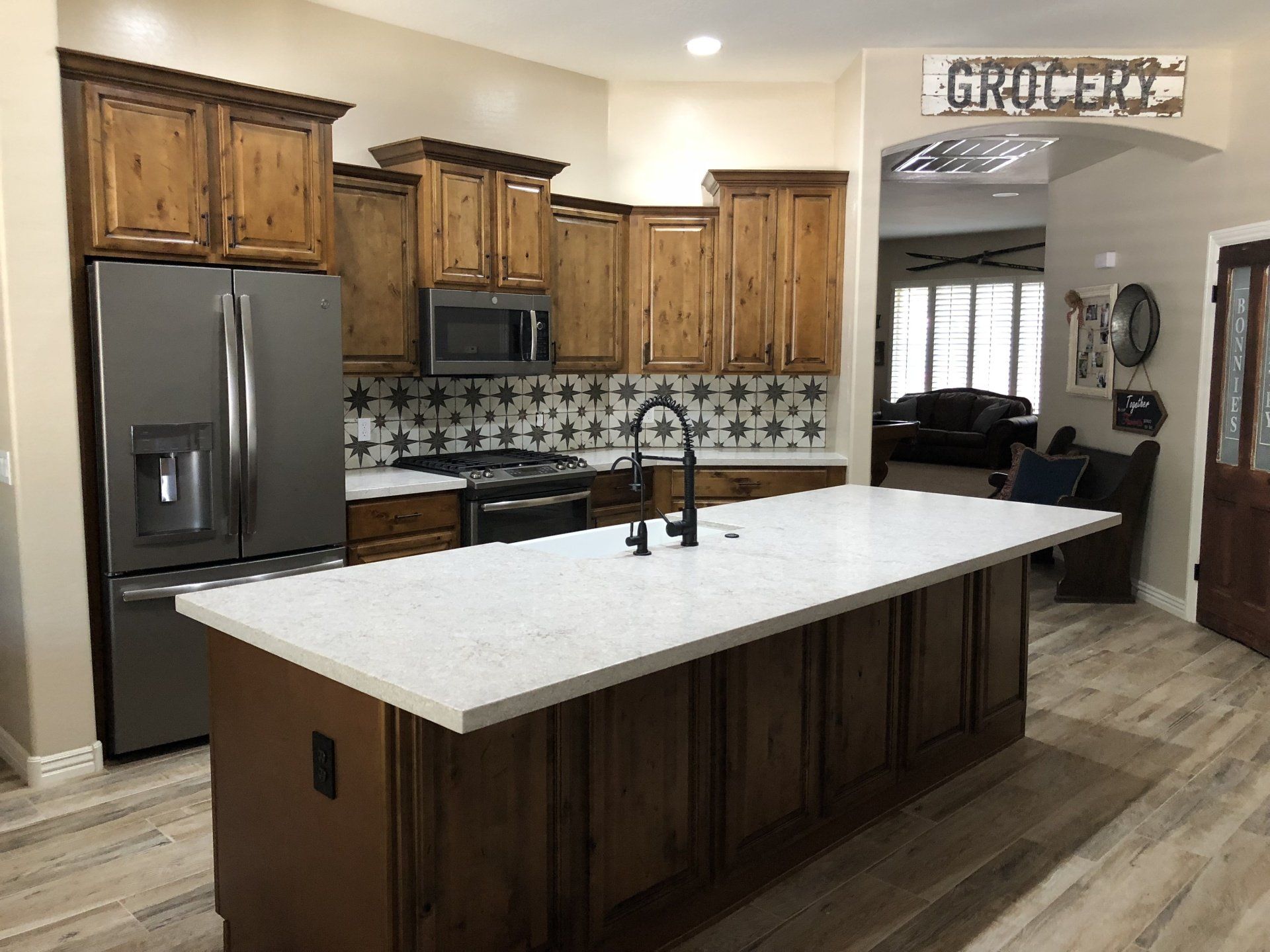 A kitchen with a large island and a sign that says groceries