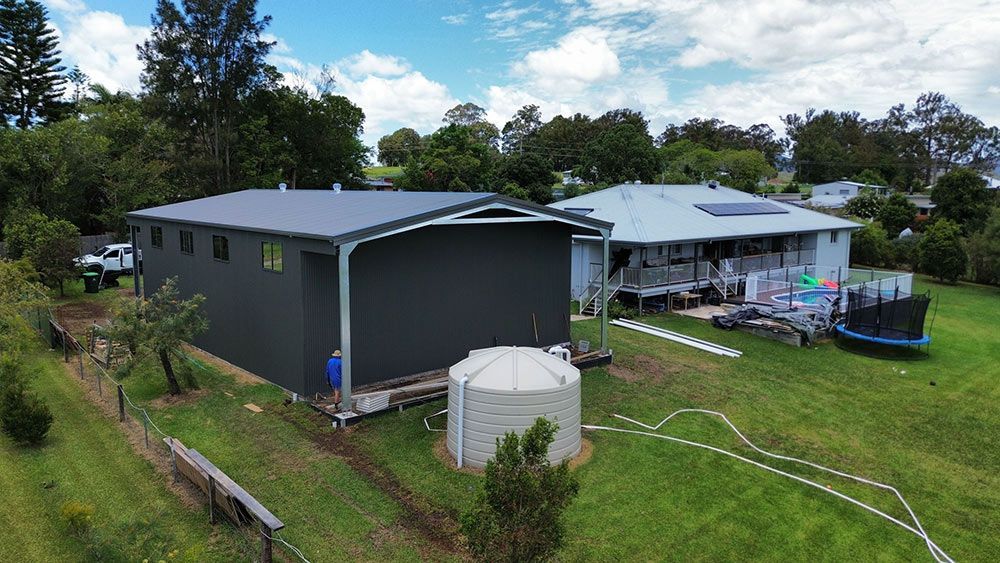 An Aerial View of a House With a Large Shed in the Backyard — Tim Leach Metal Roofing in Wauchope, NSW