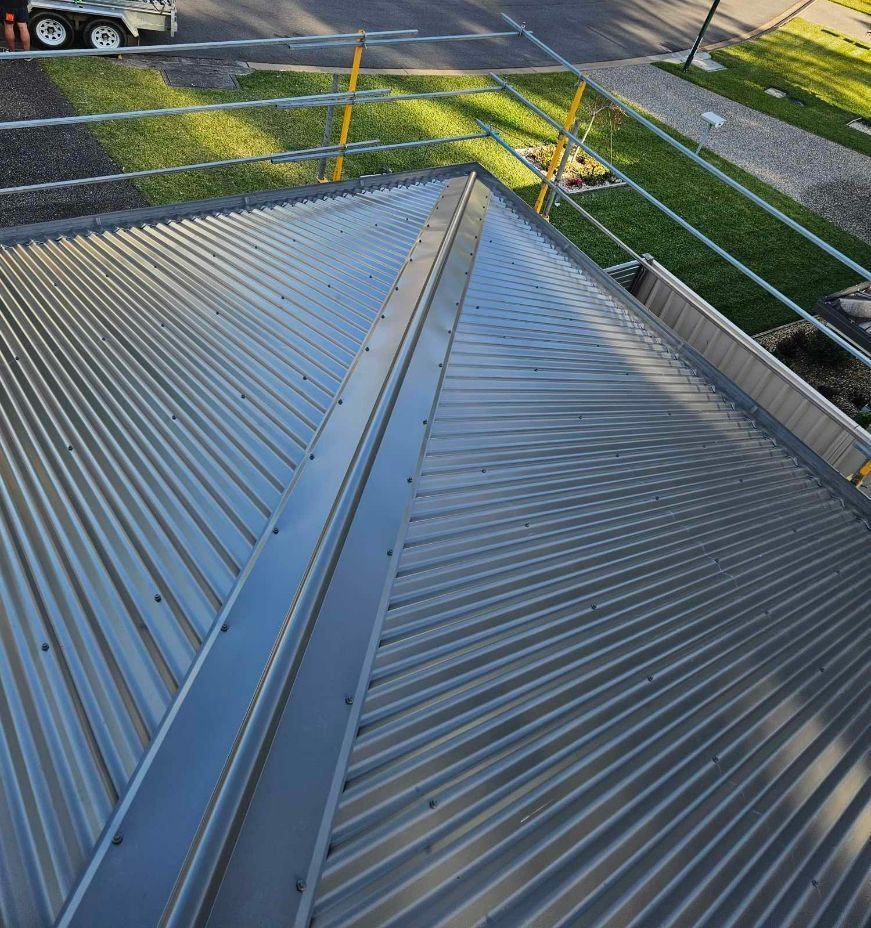 An aerial view of a metal roof with a scaffolding around it — Tim Leach Metal Roofing in Wauchope, NSW