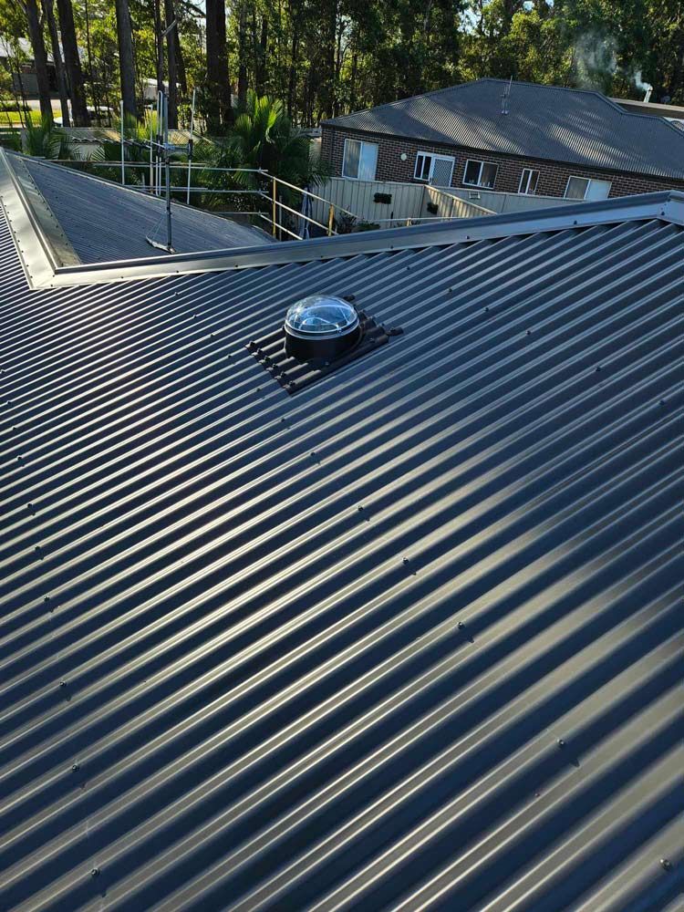 A Close Up of a Roof With a Skylight on It — Tim Leach Metal Roofing in Wauchope, NSW