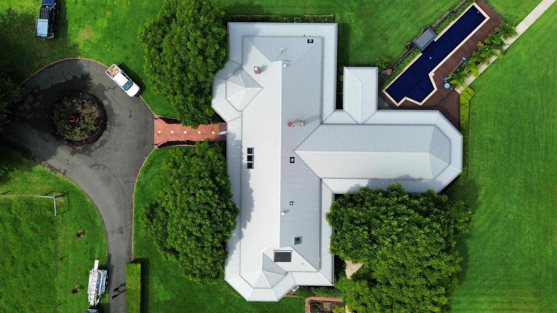 Aerial View of a Gray-roofed House With a Swimming Pool — Tim Leach Metal Roofing in Wauchope, NSW