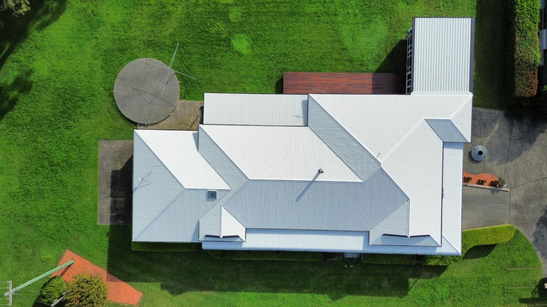 Overhead View of a House With a White Roof on a Green Lawn — Tim Leach Metal Roofing in Wauchope, NSW