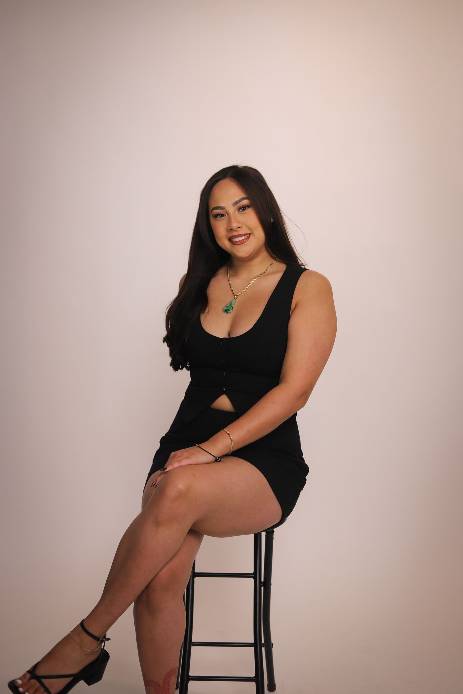 Woman in white underwear, hand adjusting fringe detail, isolated on white background.