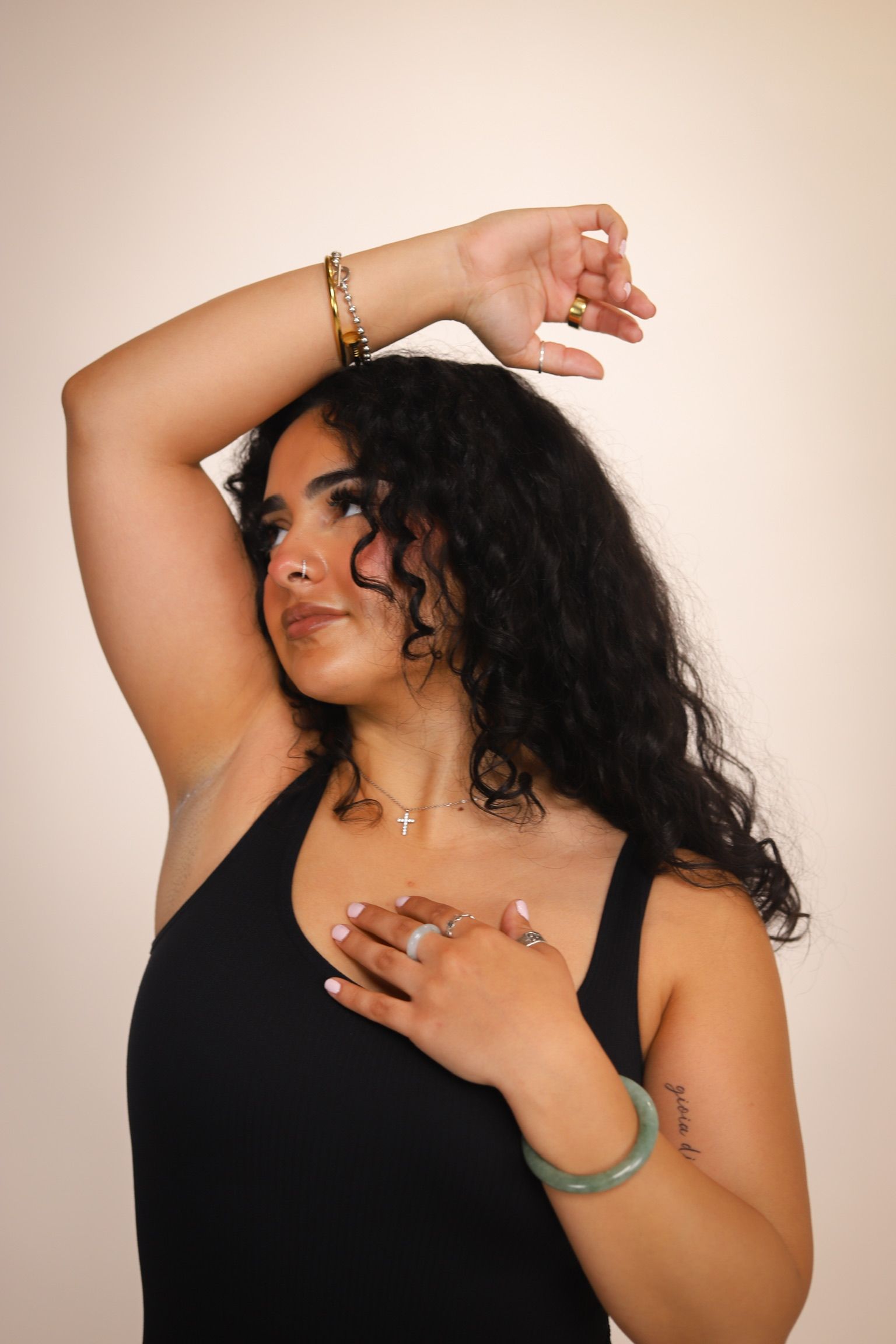 Hand holding a wooden applicator with purple wax, above a wax warmer.