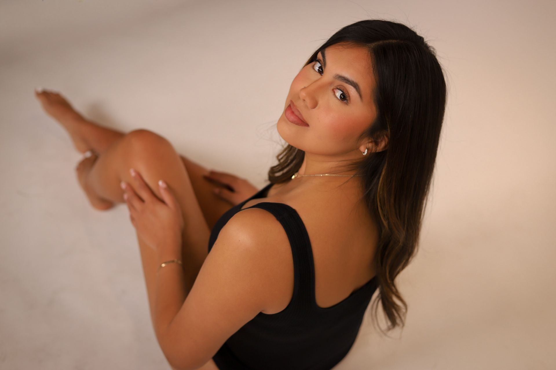Woman with closed eyes, dewy skin, and soft pink lips; close-up view.