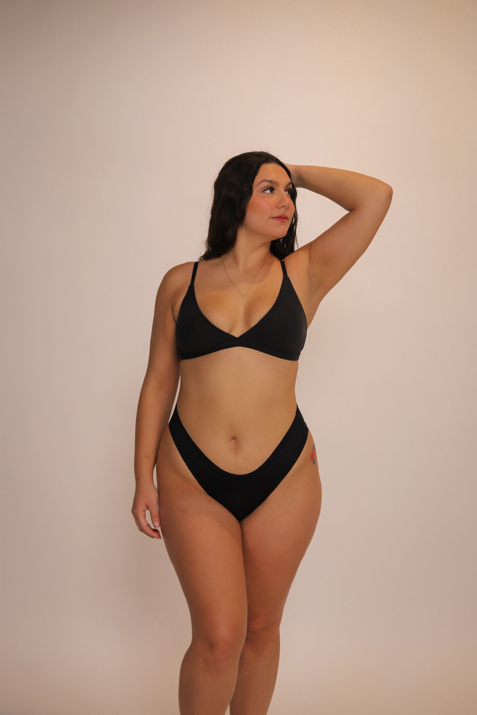 Close-up of a person with closed eyes, dewy skin, and neutral expression.