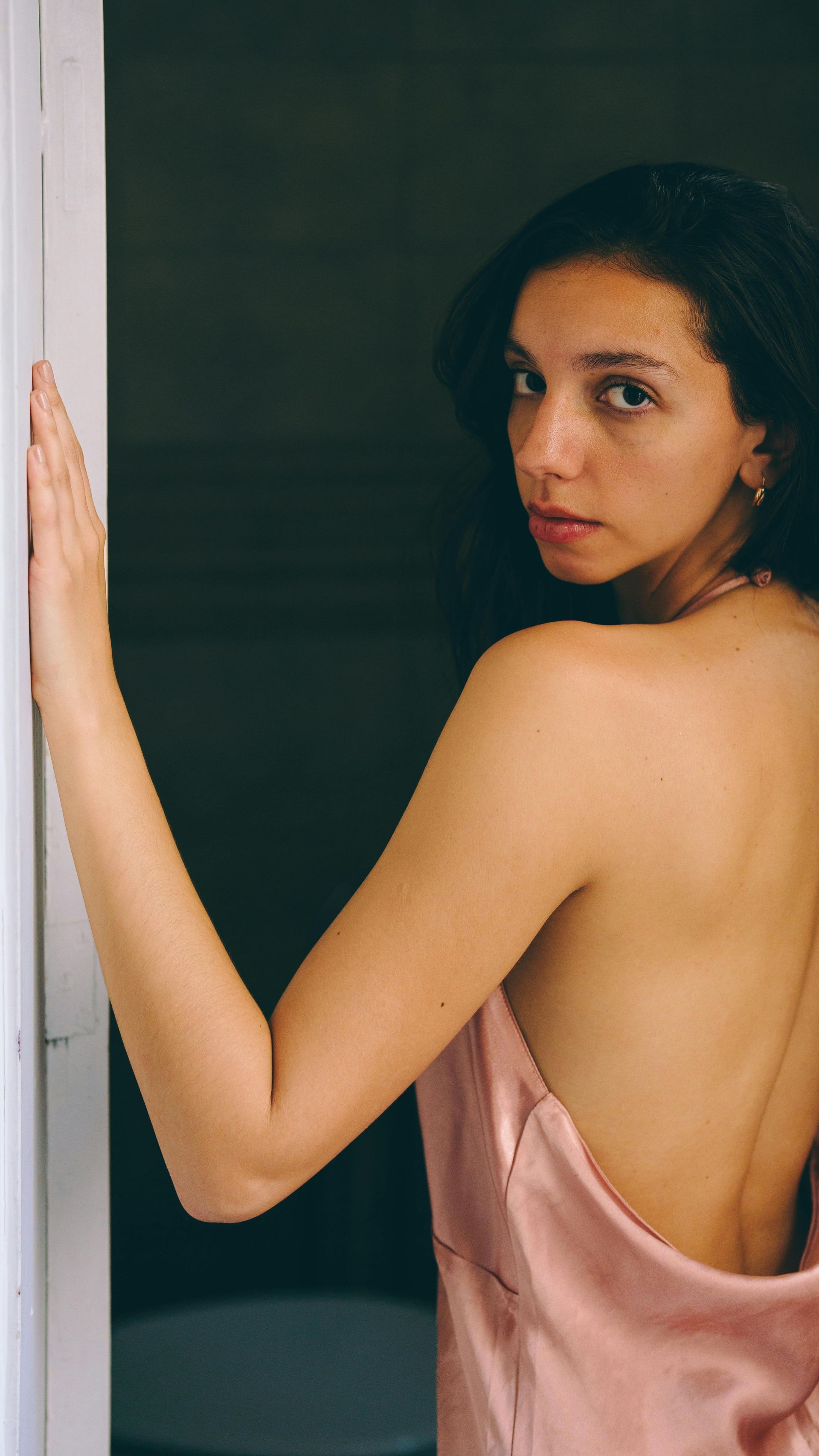 Close-up of a person with closed eyes, dewy skin, and neutral expression.