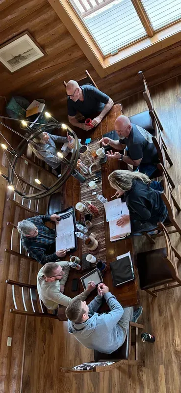 Modern office with white desks, black chairs, and computers