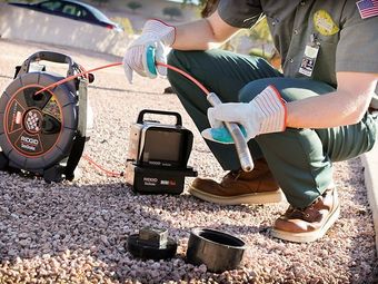 an expert cleaner is preparing to clean the drain.