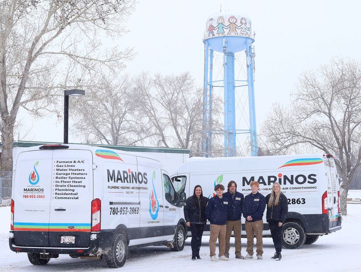 Marino's Plumbing Saskatchewan team is standing in front of their delivery bus.