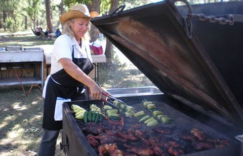 Woman Grilling Chicken — Catering and Restaurant in Camp Verde, AZ