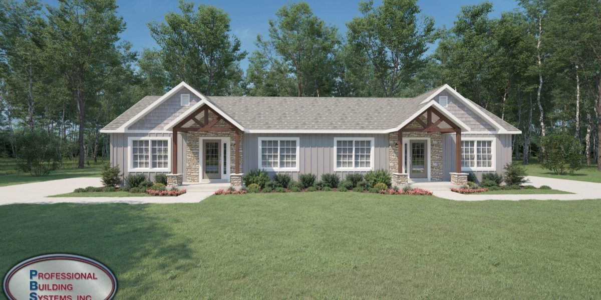 A large house with a lot of windows is sitting on top of a lush green field.