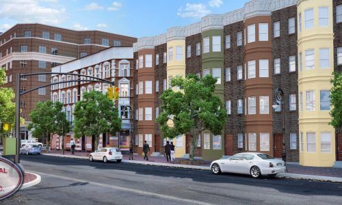 A white car is driving down a street in front of a building.