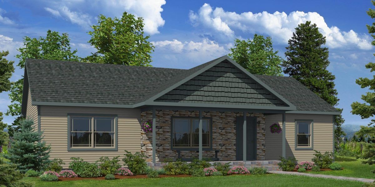 A house with a gray roof is surrounded by trees and grass.