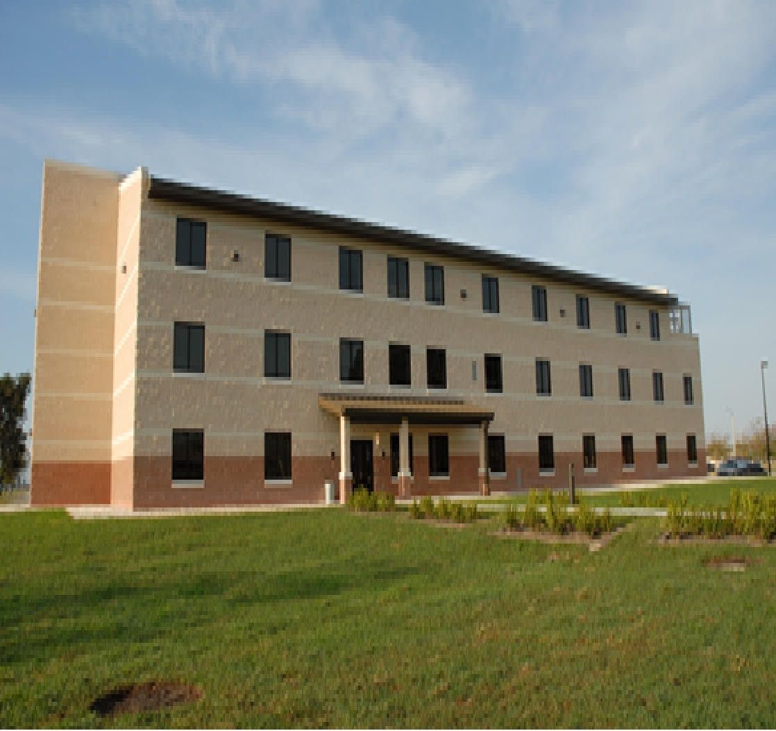 Close-up of a red circuit board with black and silver electronic components.