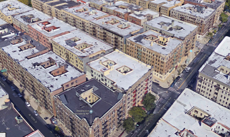 An aerial view of a football field in the middle of a forest.