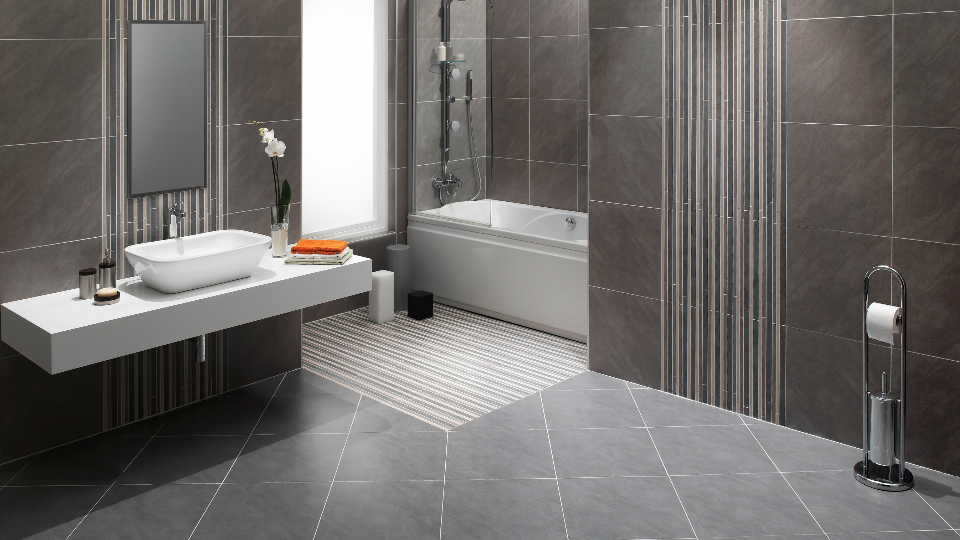 A bathroom with a sink , mirror and bathtub