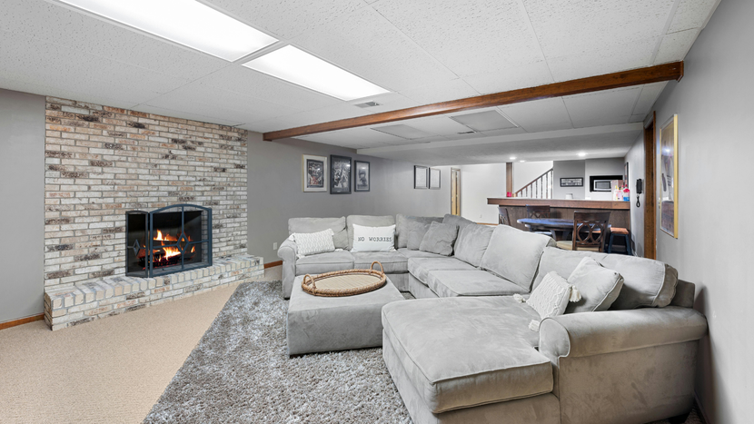 A kitchen with white cabinets , stainless steel appliances , granite counter tops and hardwood floors.