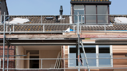 A building under construction with scaffolding on the side of it