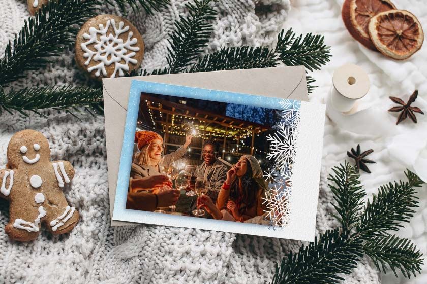 a Christmas card with a picture of a family decorating a Christmas tree