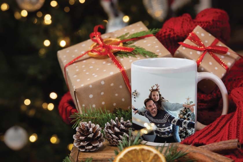 A white coffee mug with a picture of a man and a woman on it