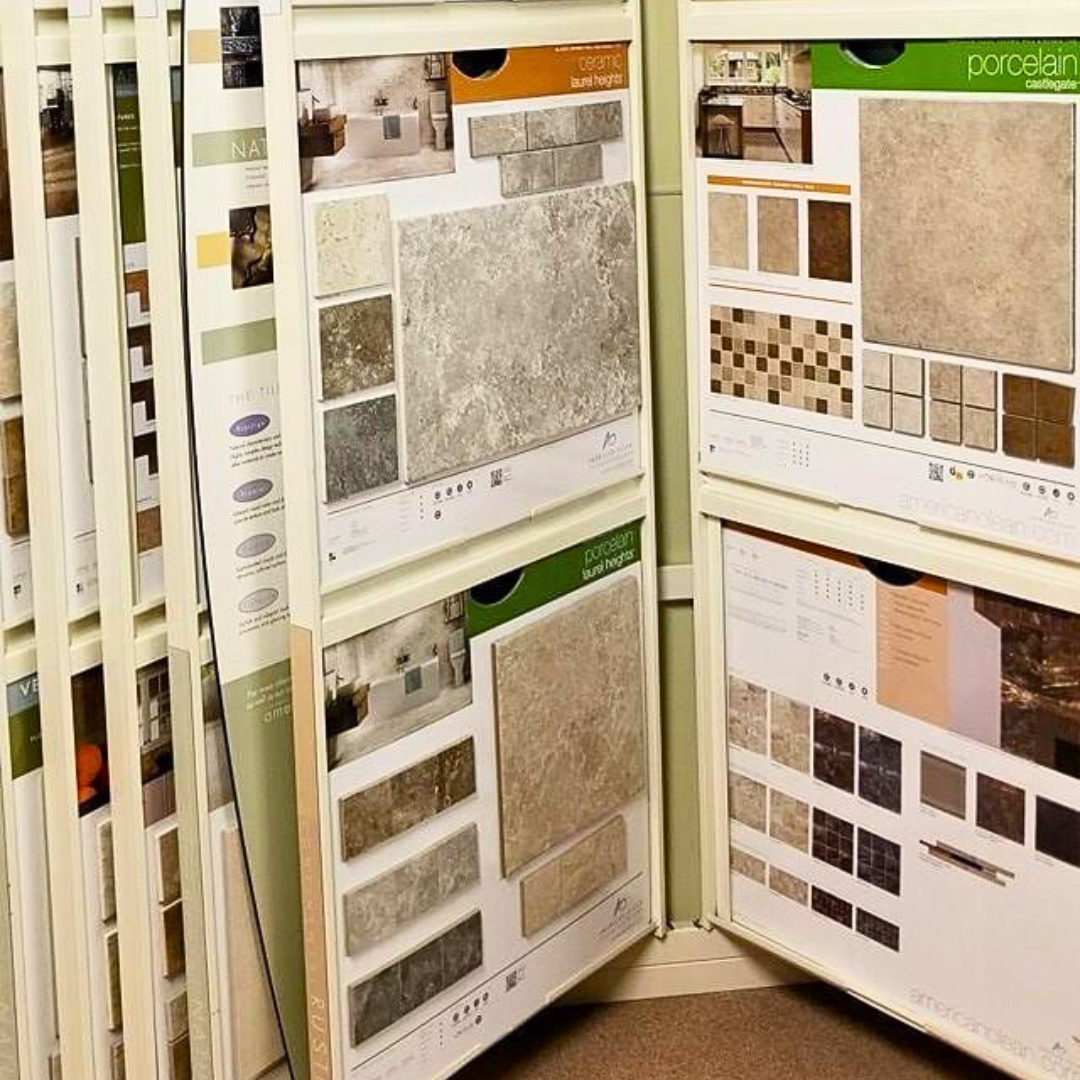 Tile samples displayed in a store. Beige and brown tiles with various textures and patterns.