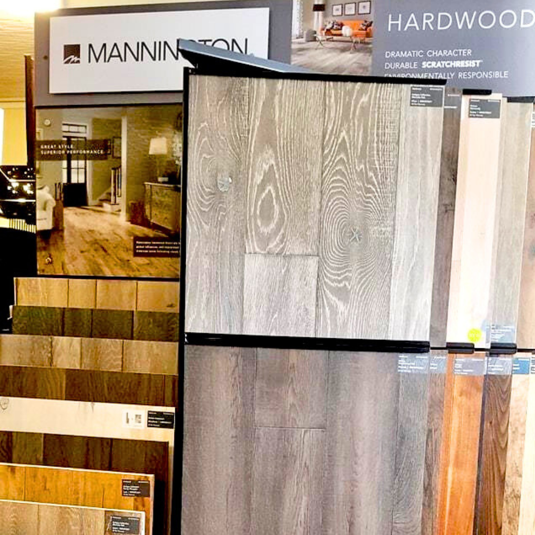 Display of hardwood flooring samples in various colors and grains.