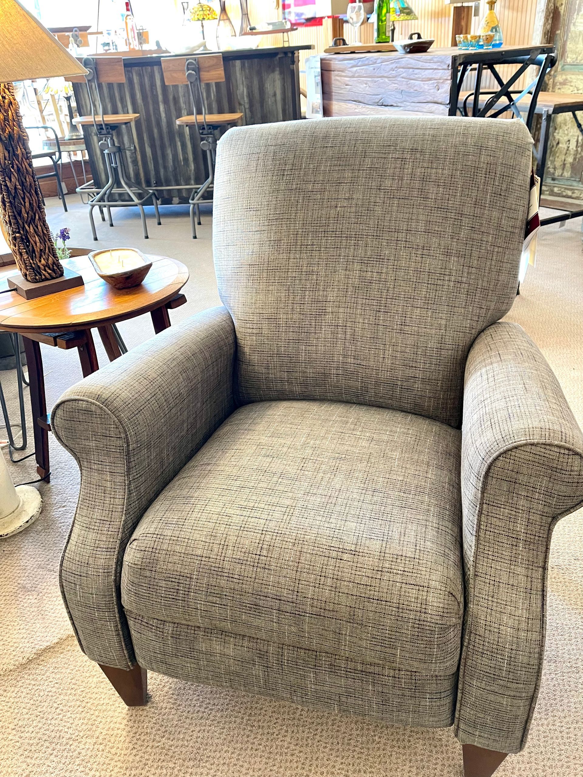 Gray patterned armchair in a shop setting.
