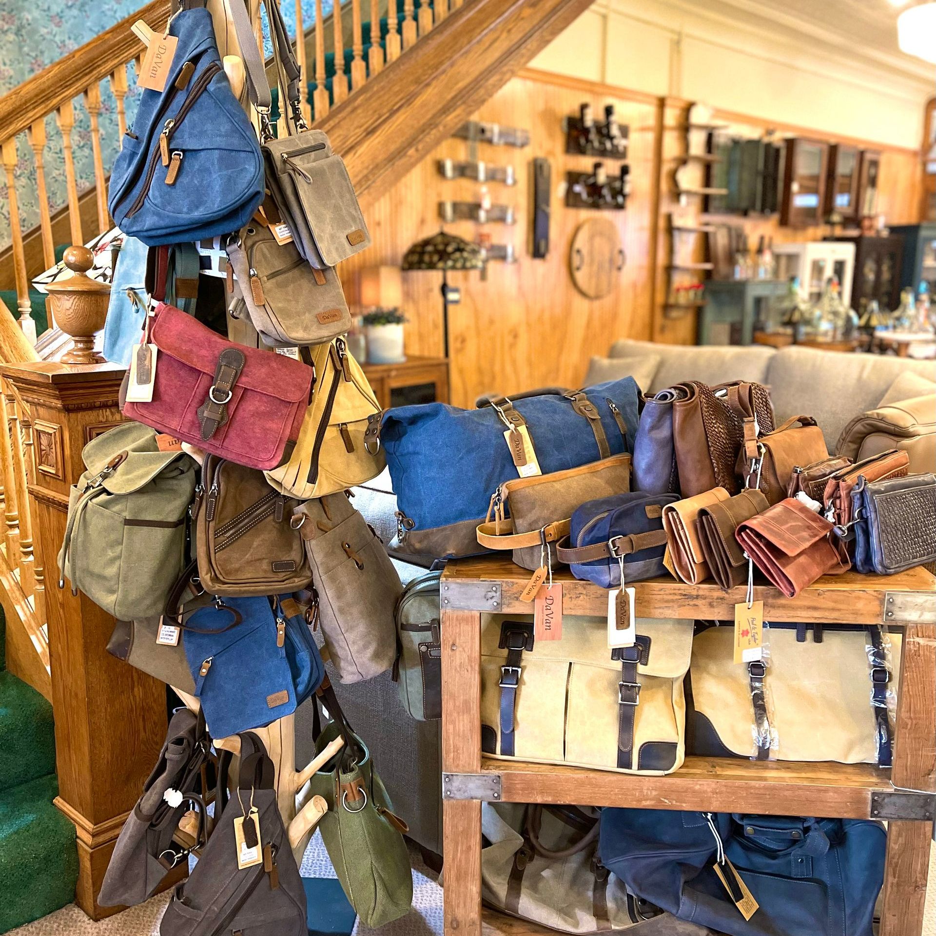 Bags in various colors and styles are displayed in a wooden shop.