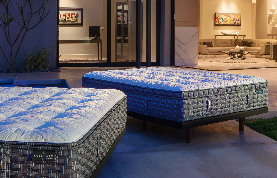 Two mattresses on a patio, one in focus. The setting is a home interior with warm lighting.
