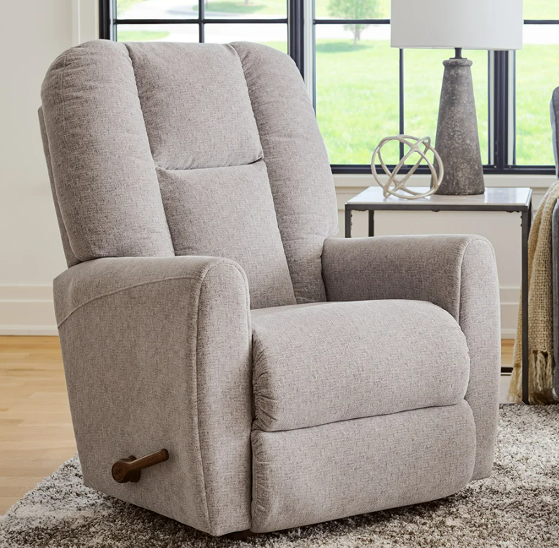 Beige upholstered recliner chair with lever, in a room with a window.
