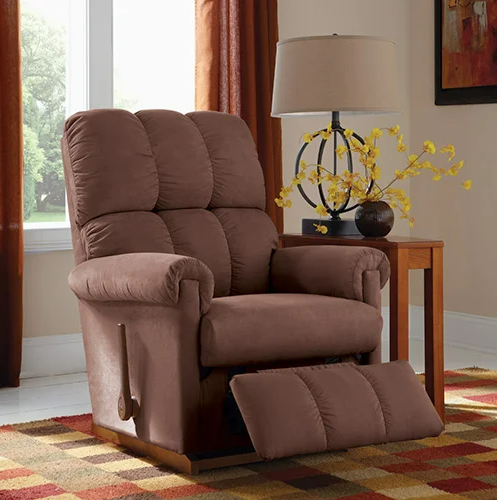 Brown recliner chair in a living room setting, with footrest extended.