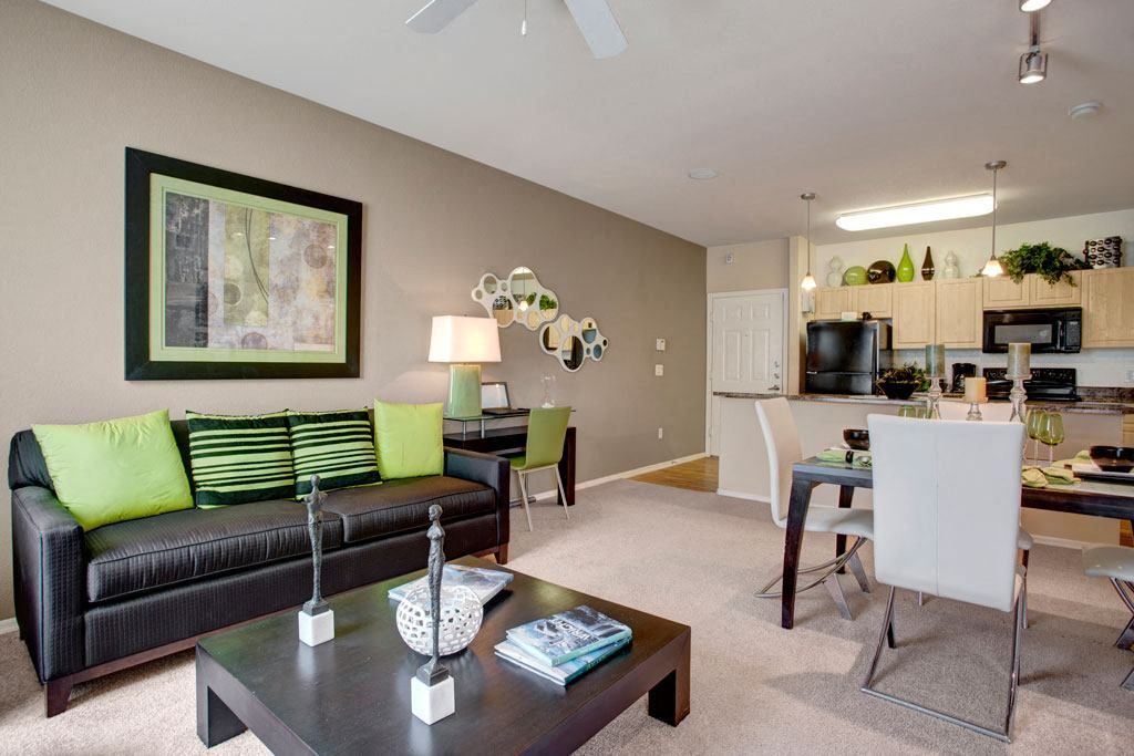 A living room with a black couch and a coffee table