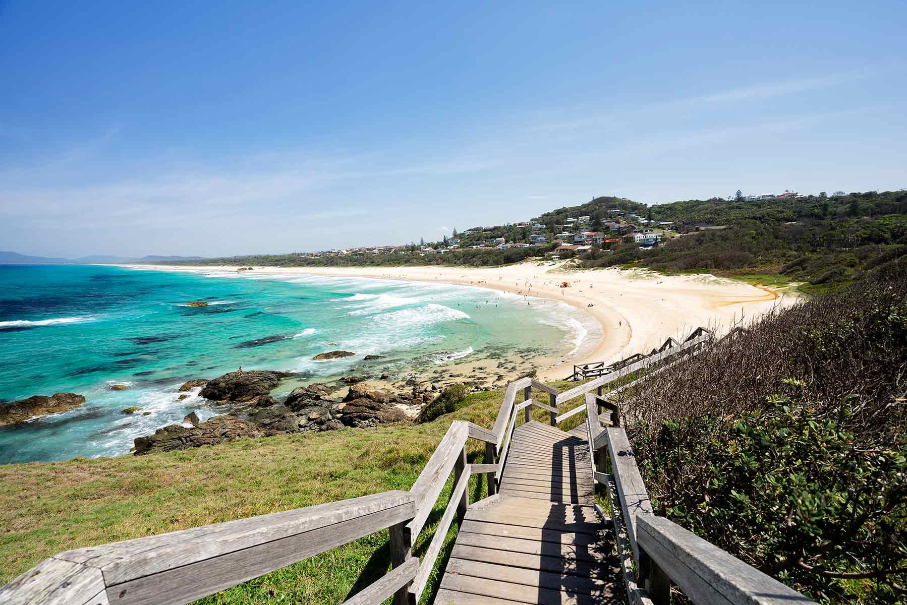 A Wooden Walkway Leading To A Beach With A View Of The Ocean — Mid Coast Coatings In Port Macquarie, NSW