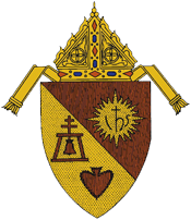 Ecclesiastical coat of arms with a miter above a shield divided diagonally, featuring a bell, IHS symbol, and a heart.