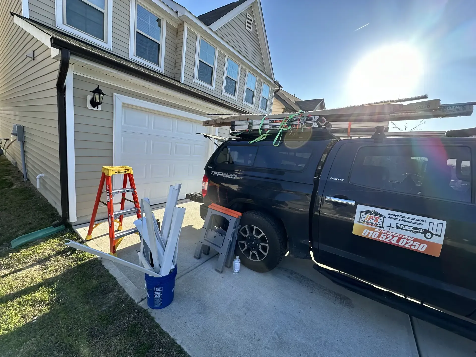 A black truck is parked in front of a house.