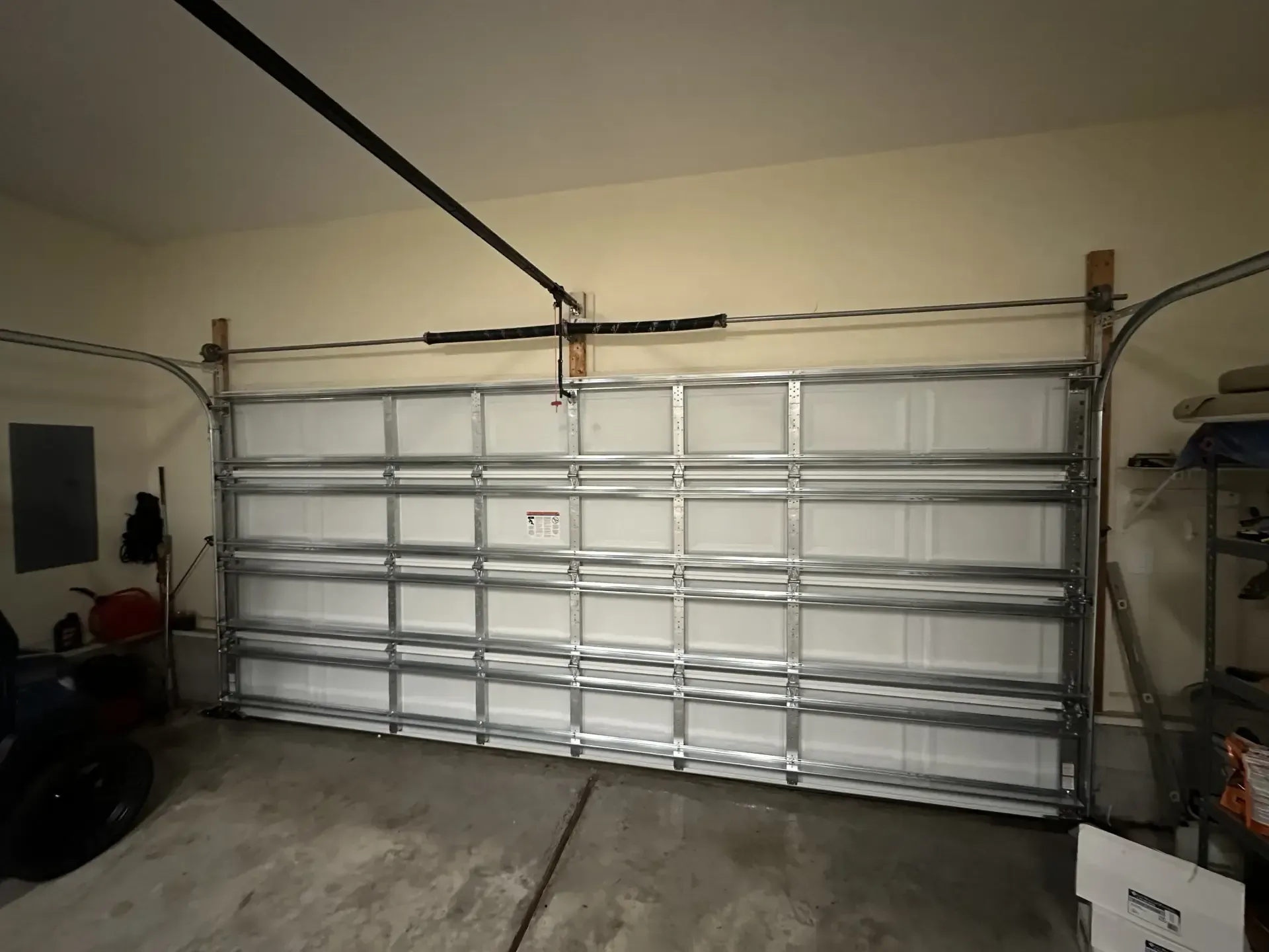 A garage with a large garage door that is open
