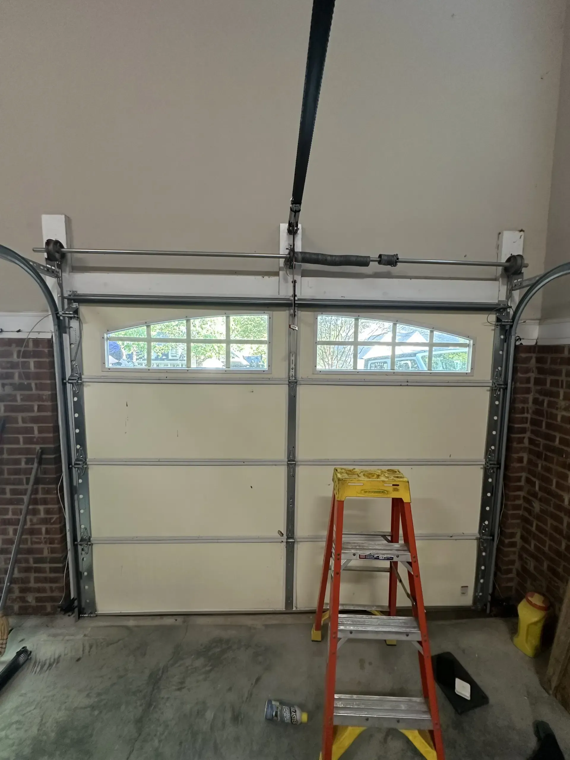 A garage door with a ladder in front of it